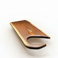 A live-edge dark walnut wooden charcuterie board with a curved, open handle set against a white background
